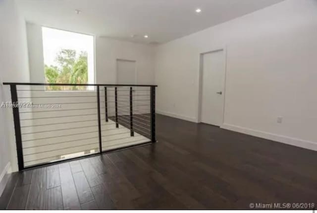 spare room featuring dark hardwood / wood-style flooring