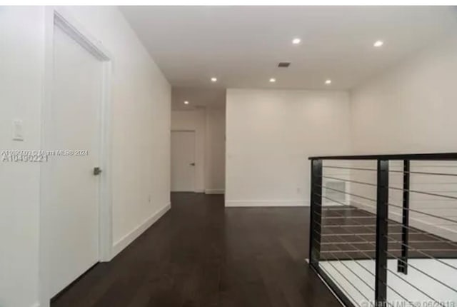 hallway with dark wood-type flooring