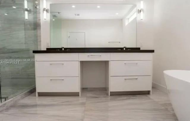 bathroom with vanity and independent shower and bath