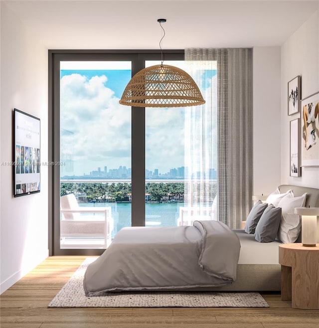 bedroom featuring a water view and hardwood / wood-style flooring