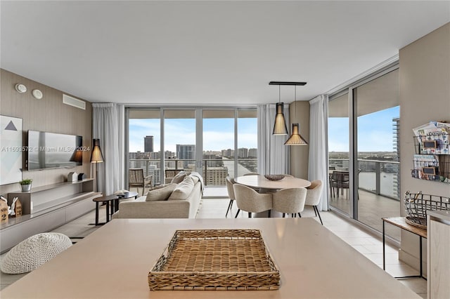 dining space featuring a water view and expansive windows