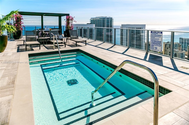 view of swimming pool with a community hot tub