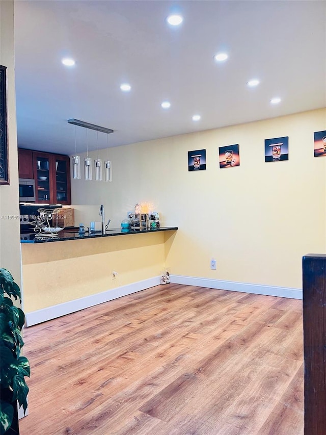 interior space featuring pendant lighting and light hardwood / wood-style floors