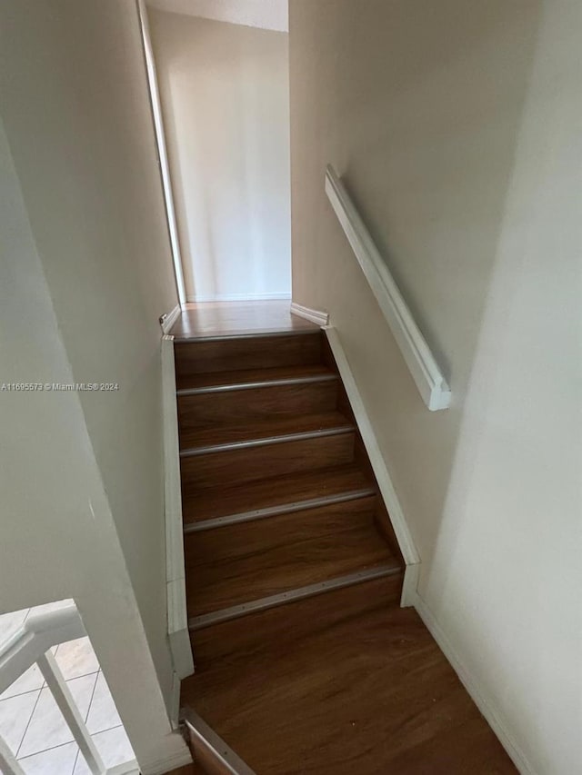 stairway featuring hardwood / wood-style flooring