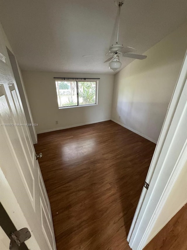 empty room featuring dark hardwood / wood-style floors and ceiling fan