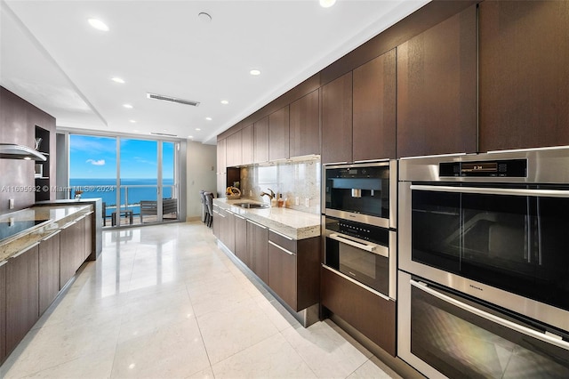 kitchen featuring dark brown cabinetry and a water view