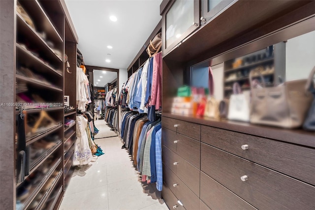 walk in closet with light tile patterned floors