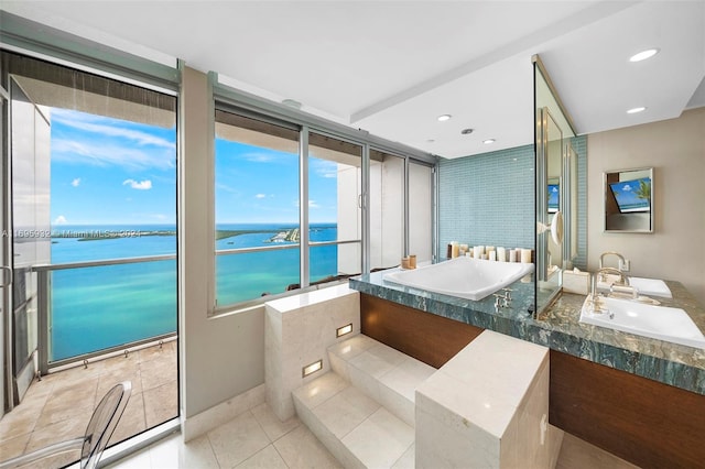 bathroom featuring tile patterned flooring, vanity, and a water view