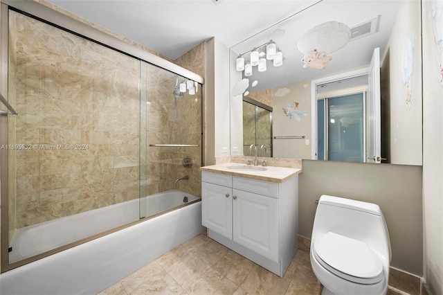 full bathroom featuring tile patterned floors, vanity, enclosed tub / shower combo, and toilet