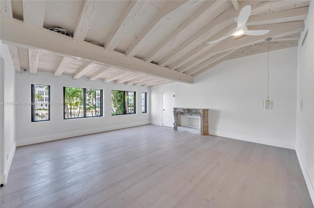 unfurnished living room with ceiling fan, lofted ceiling with beams, and wood-type flooring