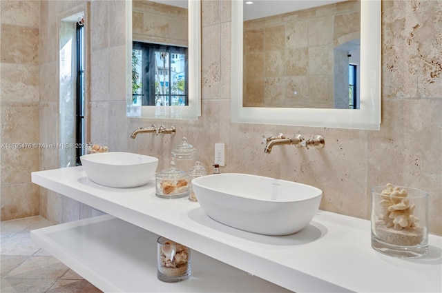 bathroom featuring tile patterned flooring, vanity, and tile walls