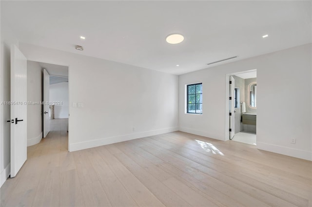 unfurnished room with light hardwood / wood-style flooring