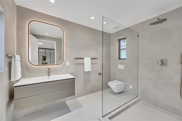 bathroom with toilet, vanity, and tiled shower