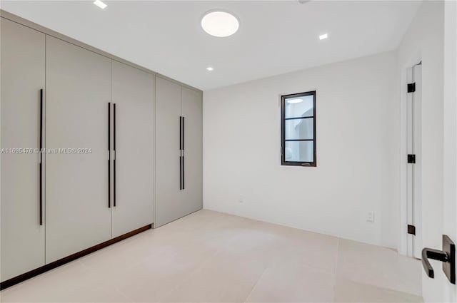 unfurnished bedroom with light tile patterned floors