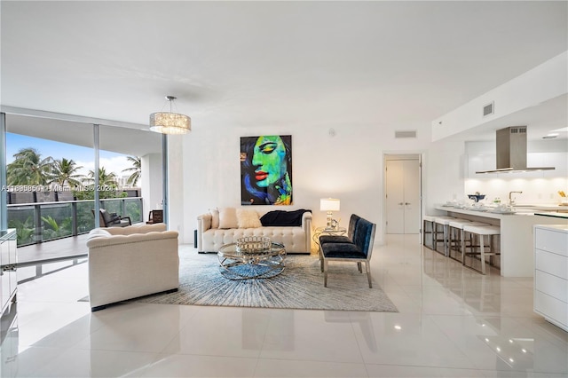 living room featuring a chandelier and light tile patterned floors