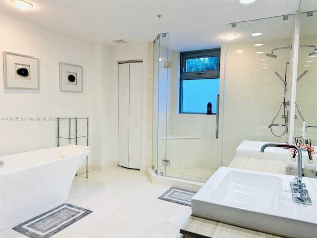 bathroom featuring separate shower and tub, sink, and tile patterned flooring