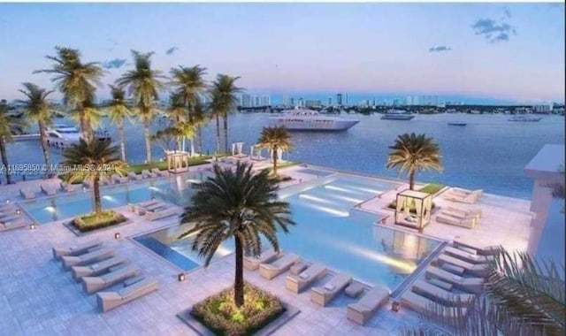 17301 Biscayne Blvd Unit 208, North Miami Beach, FL 33160 - pool at dusk featuring a water view