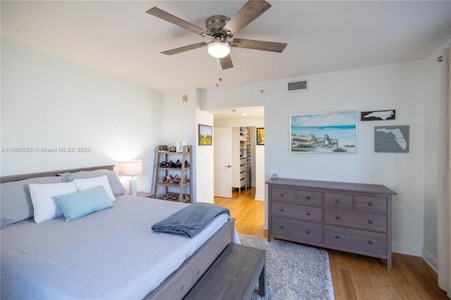 bedroom with light hardwood / wood-style flooring and ceiling fan