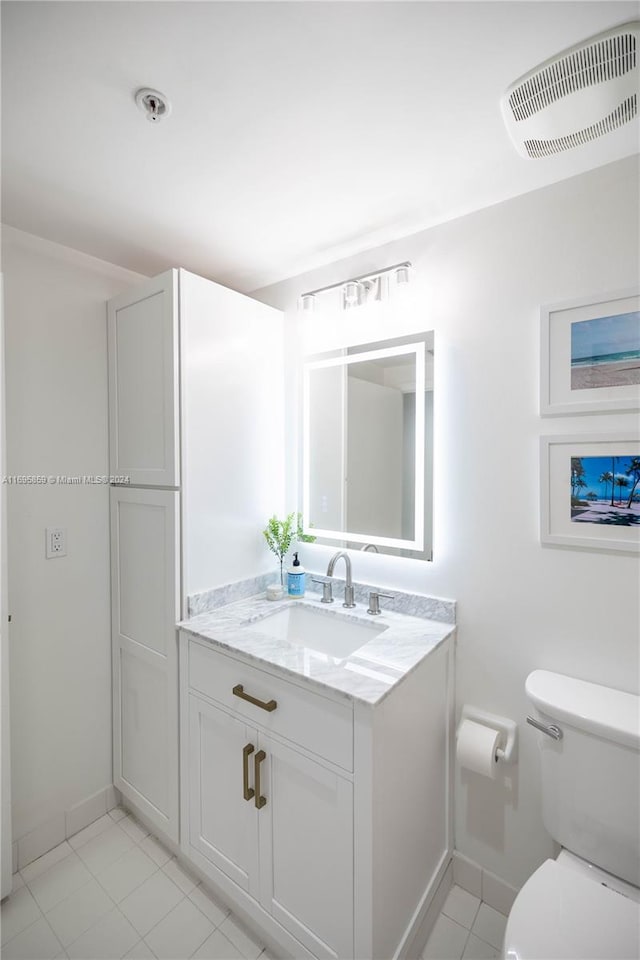 bathroom featuring tile patterned floors, vanity, and toilet