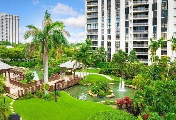 view of community with a yard and a water view