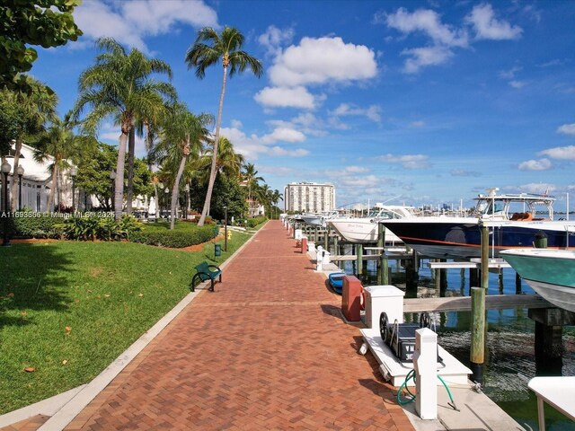 dock area featuring a lawn and a water view