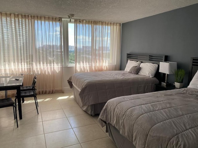 tiled bedroom featuring a textured ceiling