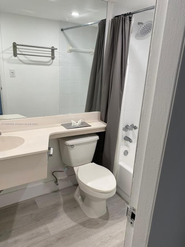 full bathroom featuring vanity, hardwood / wood-style flooring, toilet, and shower / bathtub combination with curtain