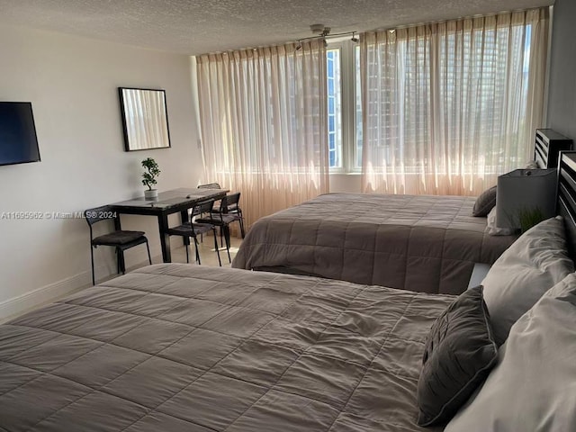 bedroom with multiple windows and a textured ceiling