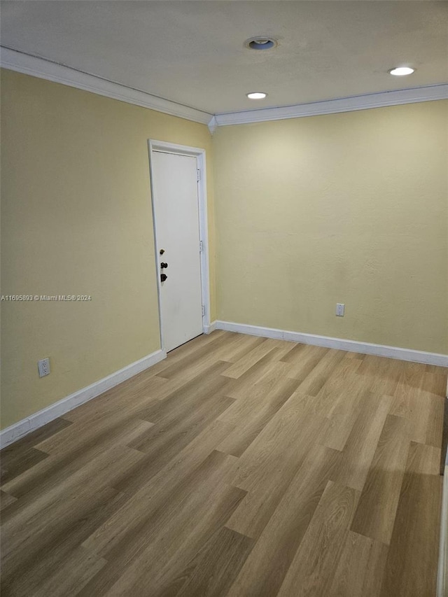 spare room with hardwood / wood-style floors and ornamental molding