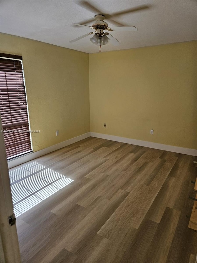 empty room featuring hardwood / wood-style floors, plenty of natural light, and ceiling fan