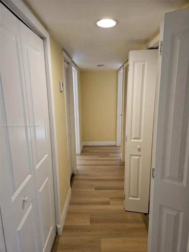 corridor featuring light wood-type flooring