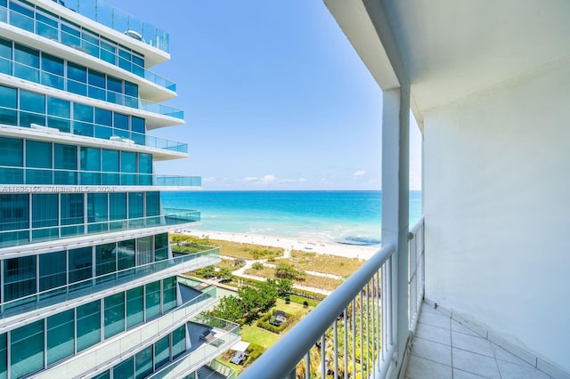 balcony with a water view and a beach view