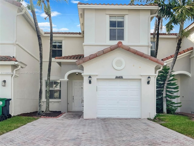 mediterranean / spanish-style house with a garage