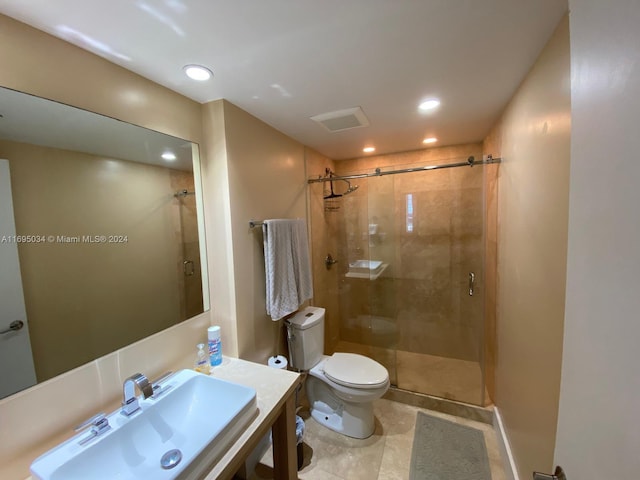 bathroom with toilet, a shower with door, and sink