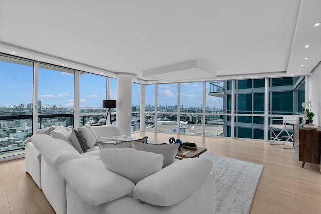 living room with light hardwood / wood-style flooring and a wall of windows