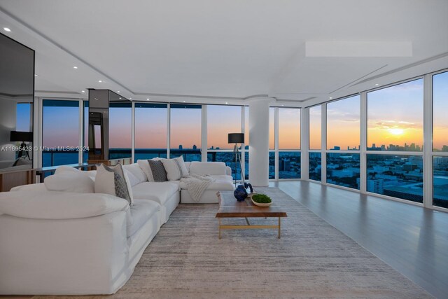 living room with expansive windows and light wood-type flooring