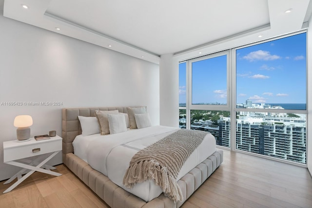 101 20th St Unit 3503/06/09, Miami Beach, FL 33139 - bedroom featuring floor to ceiling windows, wood finished floors, a raised ceiling, recessed lighting, and a view of city