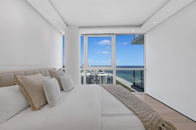 101 20th St Unit 3503/06/09, Miami Beach, FL 33139 - bedroom with a wall of windows, a water view, wood finished floors, and recessed lighting