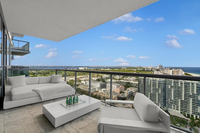 balcony with outdoor lounge area and a water view