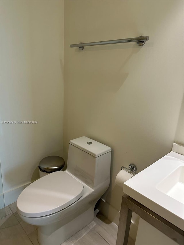 bathroom featuring tile patterned floors, vanity, and toilet