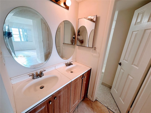 bathroom with tile patterned floors, vanity, and a textured ceiling