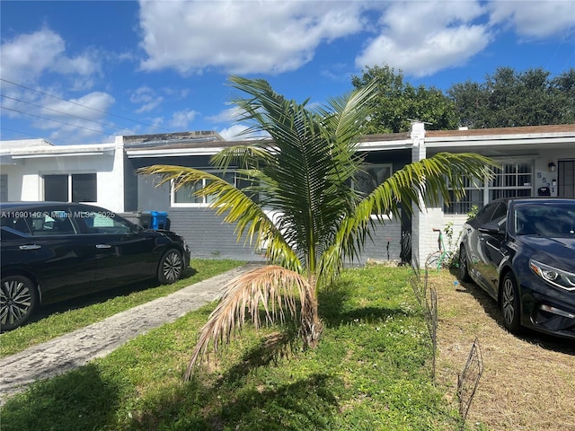 view of side of property with a yard