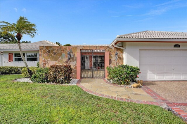 ranch-style house with a front yard and a garage