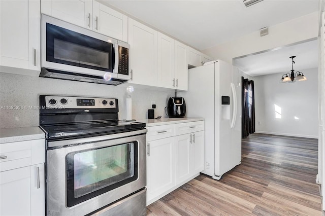 kitchen with white cabinetry, stainless steel appliances, and tasteful backsplash