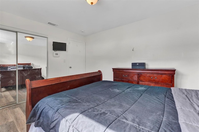 bedroom with a closet and wood-type flooring