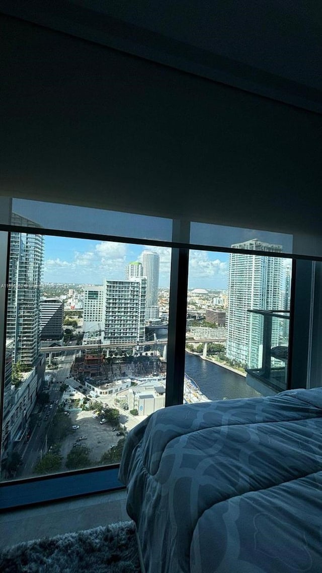 bedroom featuring multiple windows and a water view