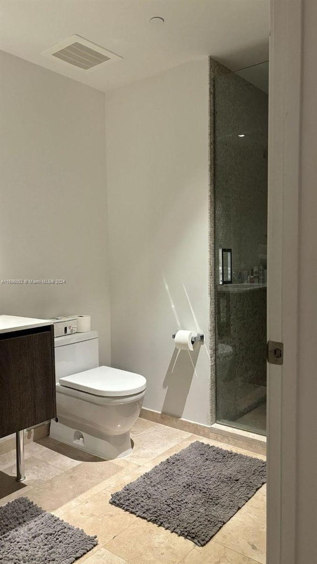 bathroom with an enclosed shower and toilet