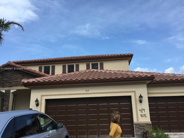 mediterranean / spanish-style house featuring a garage