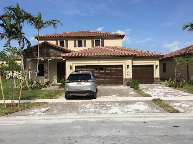 515 SE 35th Ave, Homestead, FL 33033 - mediterranean / spanish house featuring an attached garage, stucco siding, concrete driveway, and stone siding