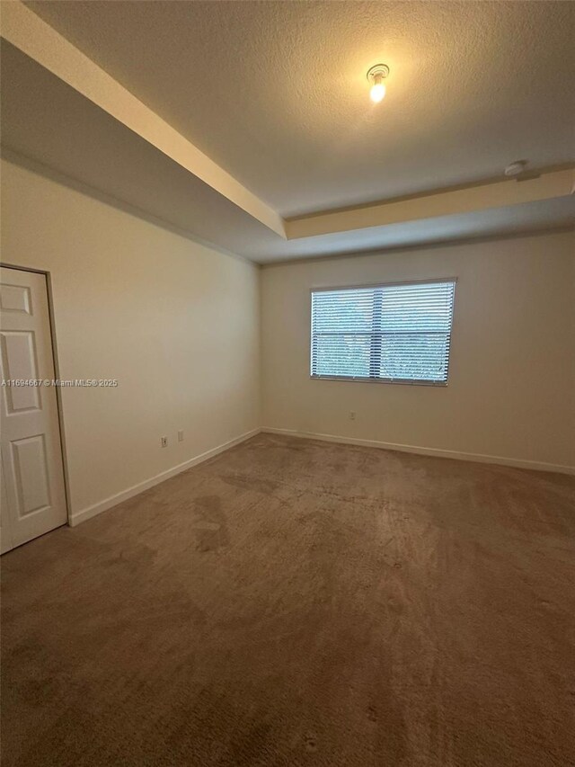 515 SE 35th Ave, Homestead, FL 33033 - carpeted empty room with baseboards and a textured ceiling